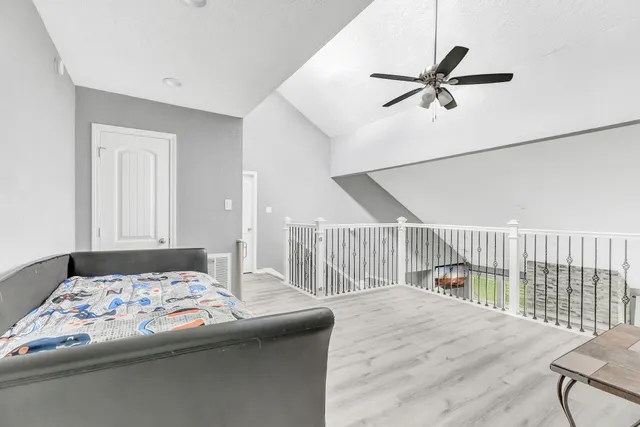 a bedroom with a bed and a chandelier