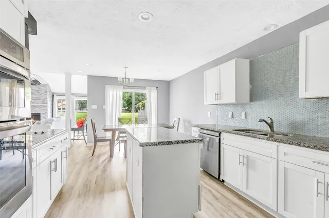 a kitchen with a sink stove and cabinets