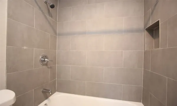 a bathroom with a shower and toilet