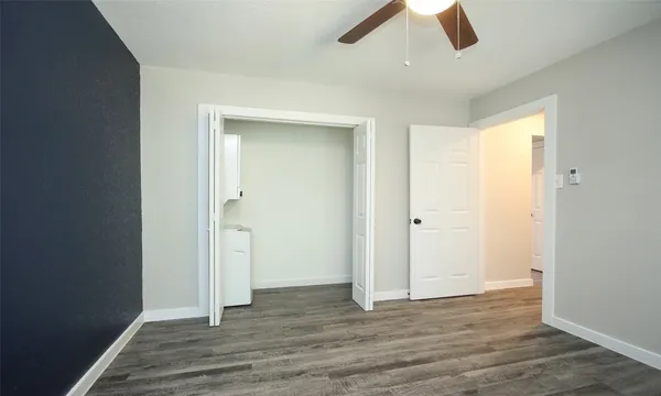 a view of empty room with wooden floor