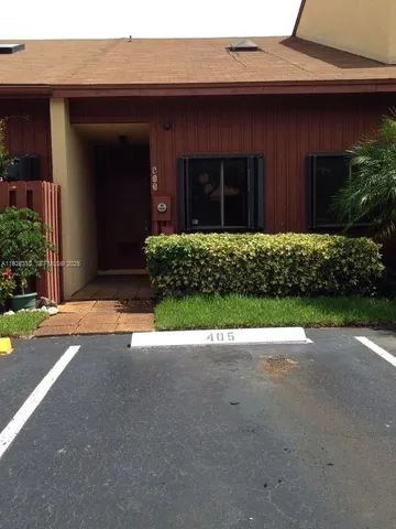 a view of brick house with a yard