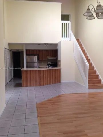 a view of a living room with furniture and kitchen