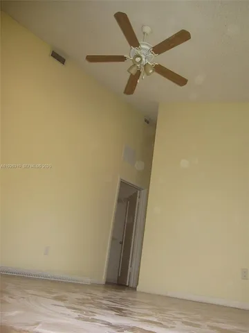 a view of a room with wooden floor and cabinet