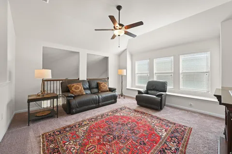 a living room with furniture and a rug