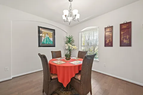 a dining room with furniture and chandelier
