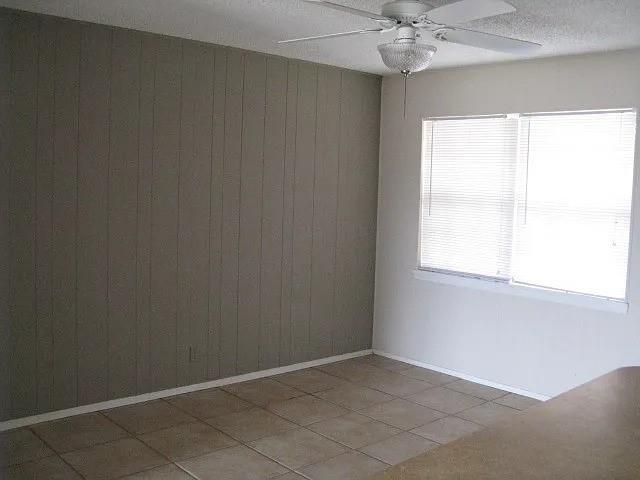 4004 Vicky Street Big Spring, TX 79720 - Photo 11 of 13 Room featuring tile flooring and a paneled accent wall