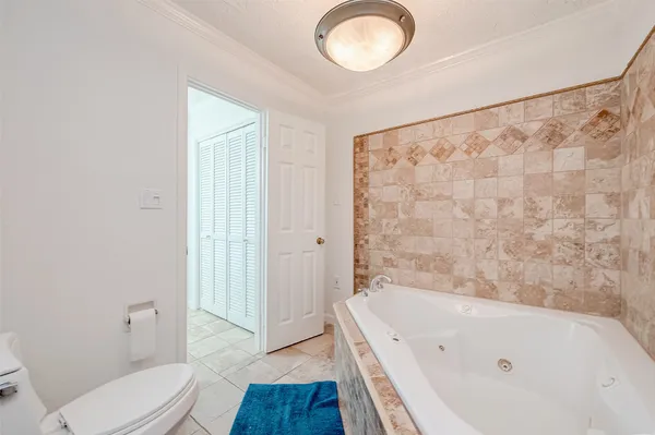 a bathroom with a bathtub and a toilet