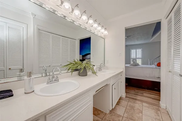 a bathroom with a double vanity sink and a mirror
