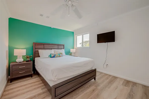 a bedroom with a bed and a flat screen tv