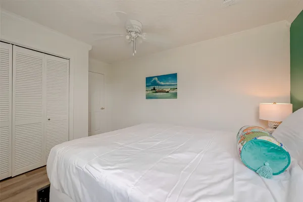 a bedroom with a bed and a painting on the wall