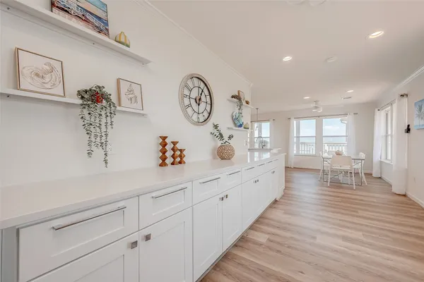 a large white kitchen with a large window