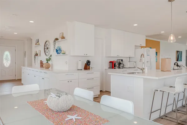 a large white kitchen with white cabinets