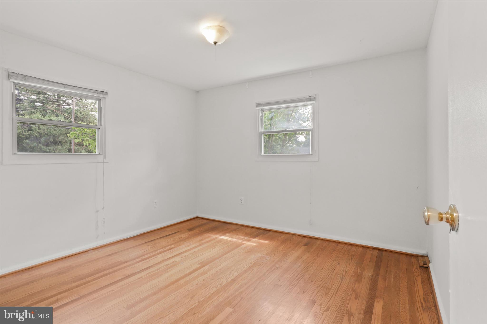 10205 Rodgers Road Fairfax, VA 22030 - Photo 13 of 41 an empty room with a window and wooden floor