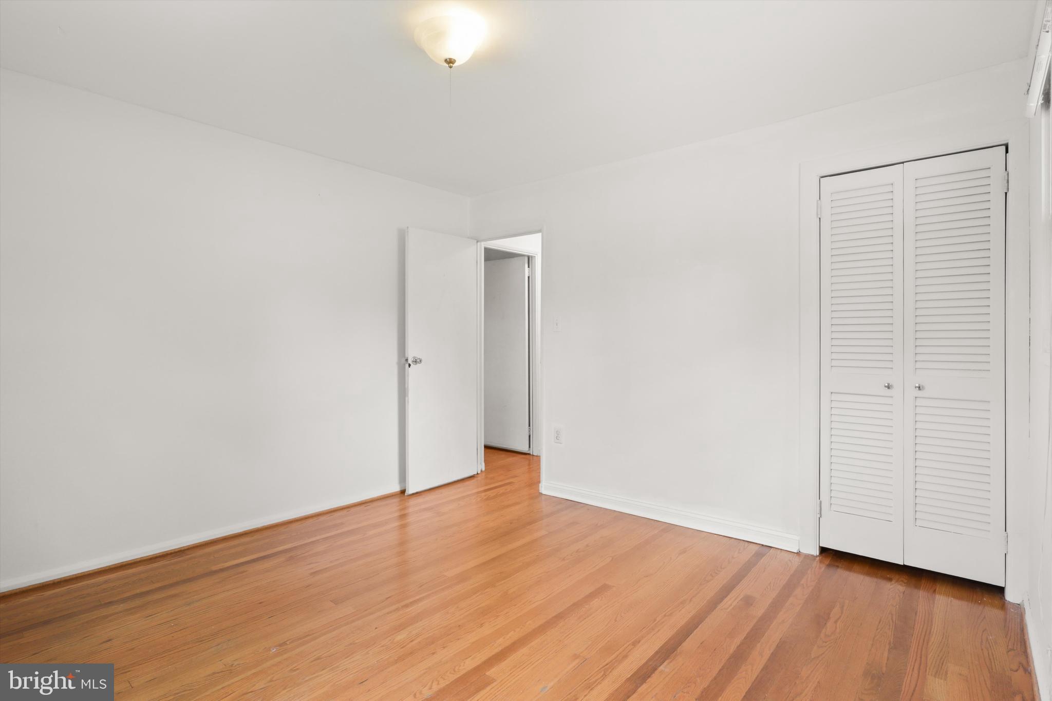 10205 Rodgers Road Fairfax, VA 22030 - Photo 14 of 41 an empty room with wooden floor and windows