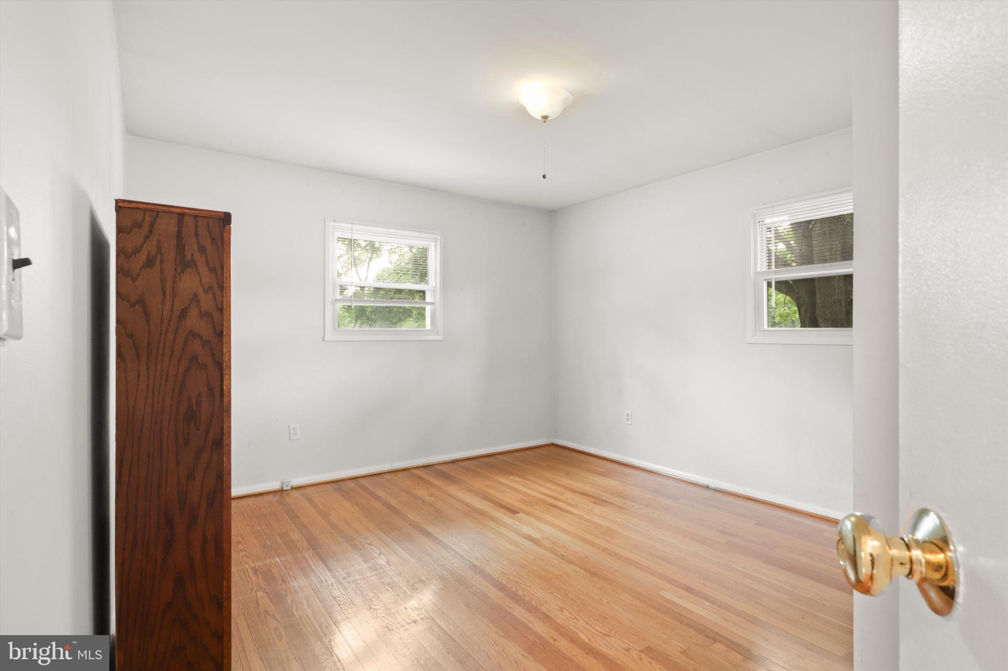10205 Rodgers Road Fairfax, VA 22030 - Photo 16 of 41 an empty room with wooden floor and windows