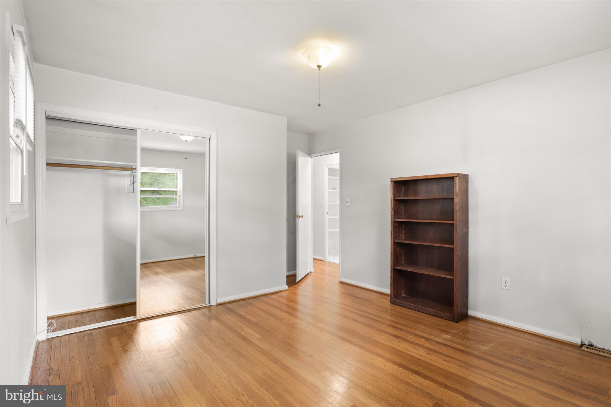 10205 Rodgers Road Fairfax, VA 22030 - Photo 17 of 41 an empty room with wooden floor and closet