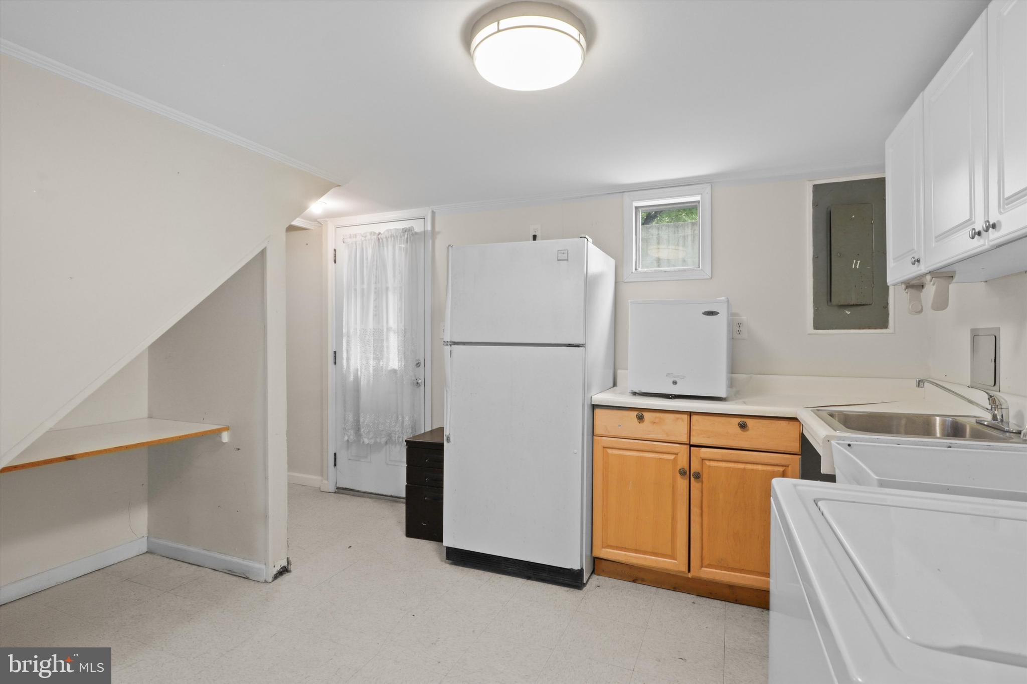 10205 Rodgers Road Fairfax, VA 22030 - Photo 23 of 41 a white refrigerator freezer sitting in a kitchen