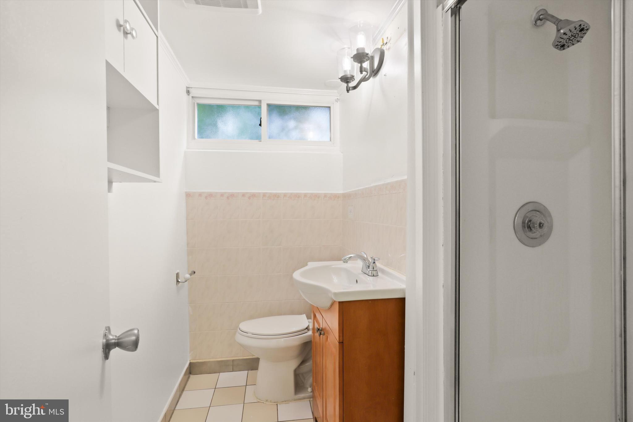 10205 Rodgers Road Fairfax, VA 22030 - Photo 31 of 41 a white toilet sitting next to a bathroom sink