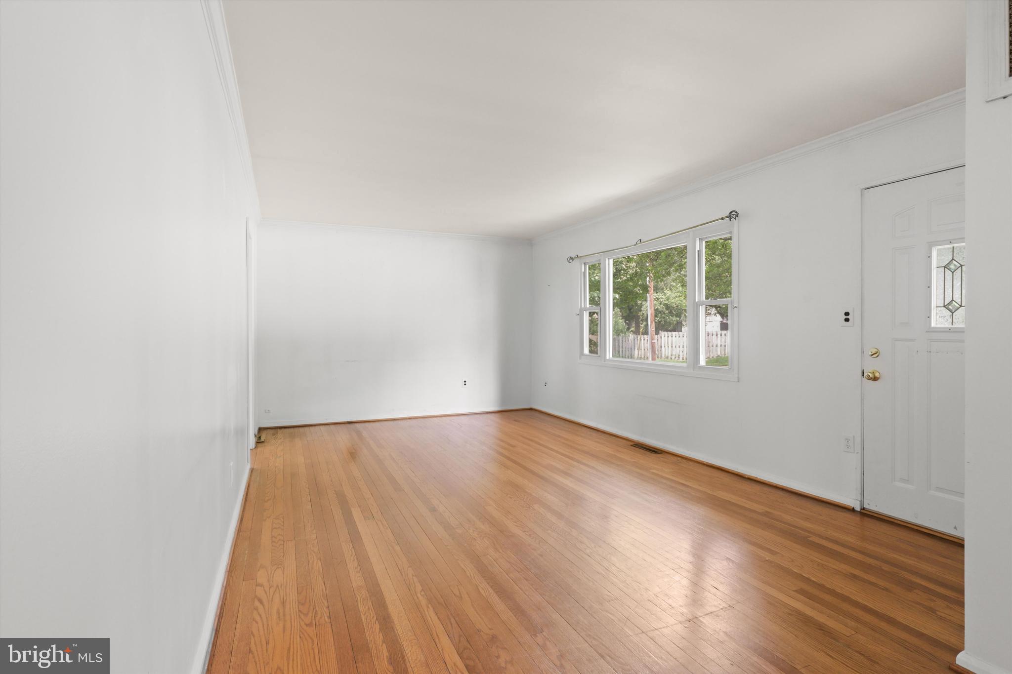 10205 Rodgers Road Fairfax, VA 22030 - Photo 5 of 41 an empty room with wooden floor and windows