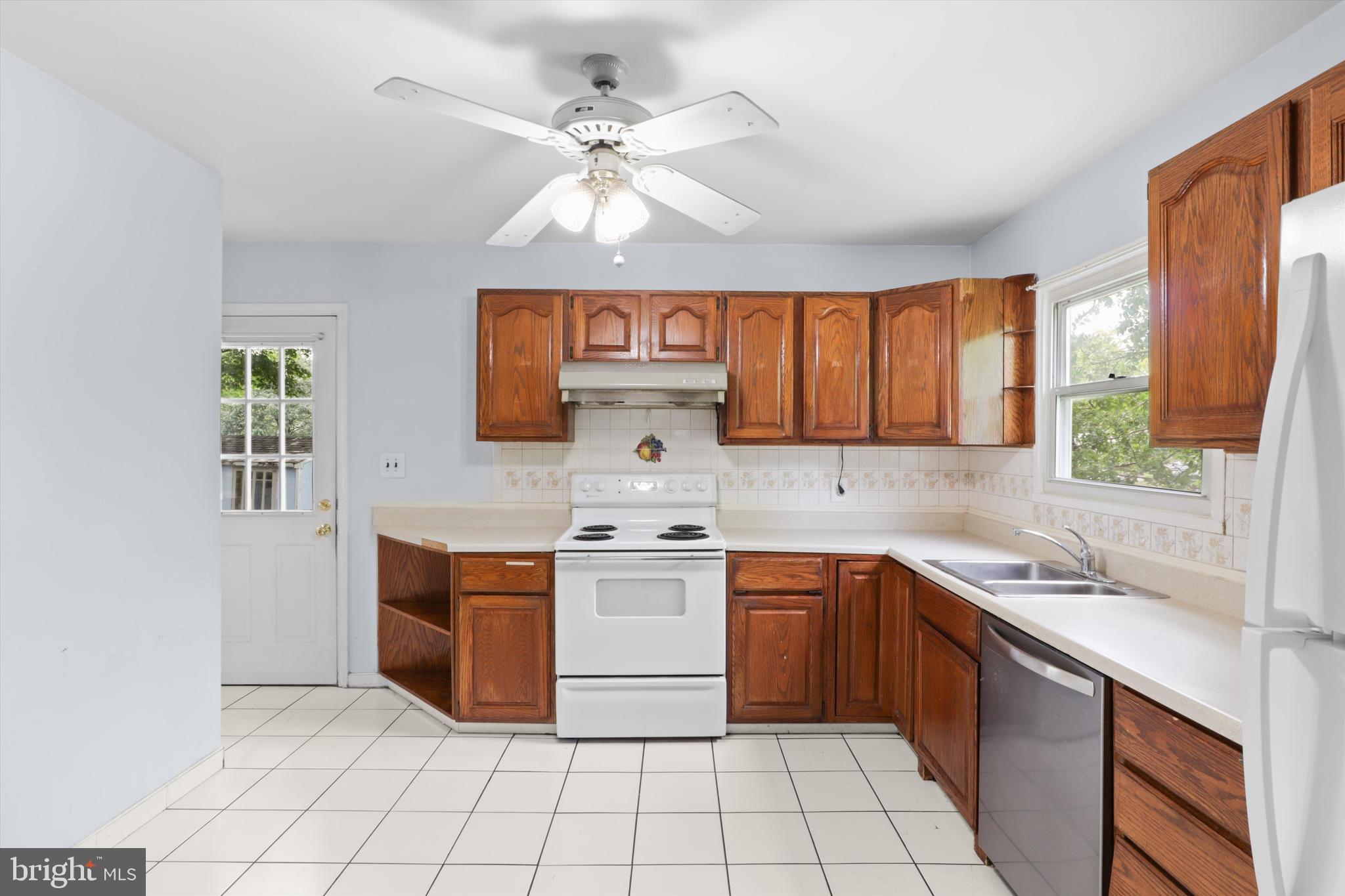 10205 Rodgers Road Fairfax, VA 22030 - Photo 7 of 41 a kitchen with stainless steel appliances a sink stove and cabinets
