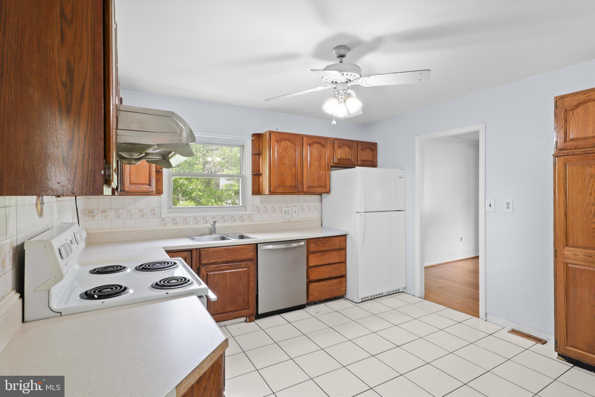 10205 Rodgers Road Fairfax, VA 22030 - Photo 9 of 41 a kitchen with stainless steel appliances a stove a sink and a refrigerator