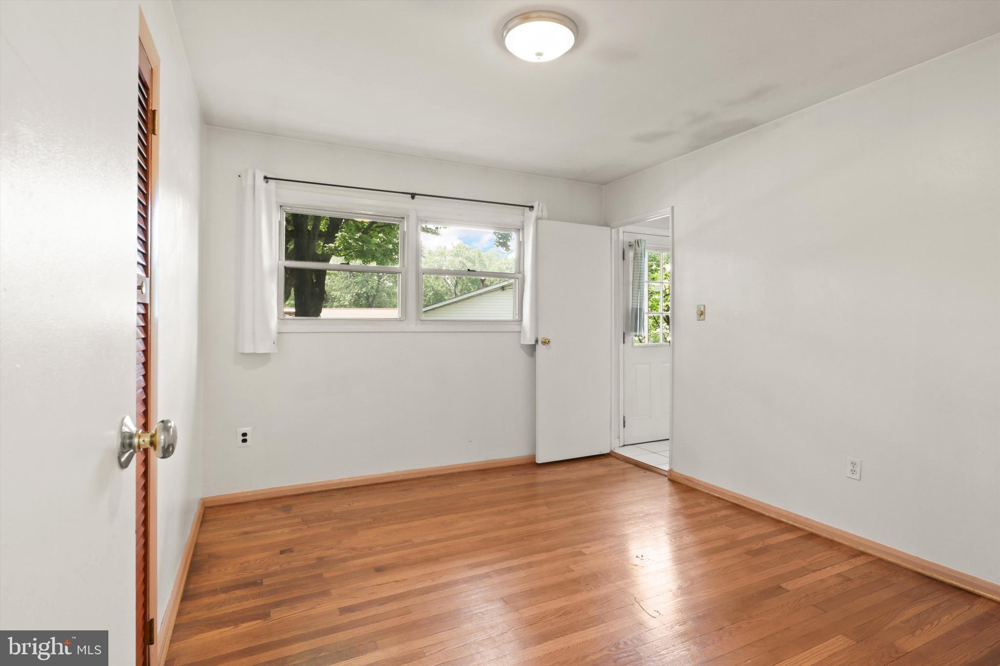 10205 Rodgers Road Fairfax, VA 22030 - Photo 10 of 41 an empty room with wooden floor and windows