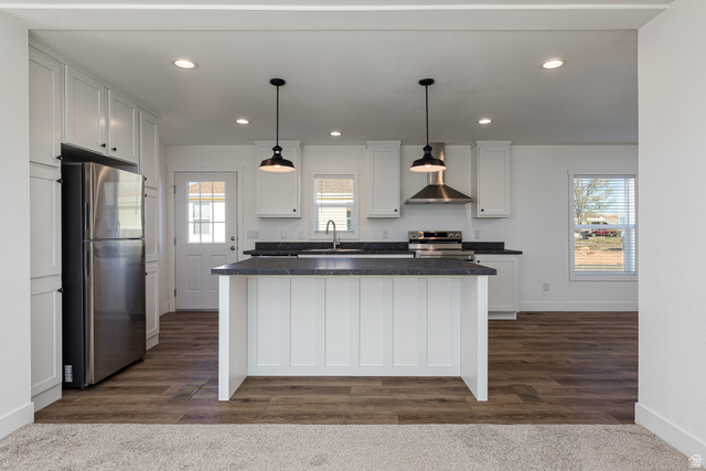 749 Riddle Drive Fredonia, AZ 86022 - Photo 17 of 41 Kitchen featuring stainless steel appliances, white cabinetry, dark wood-type flooring, and pendant lighting