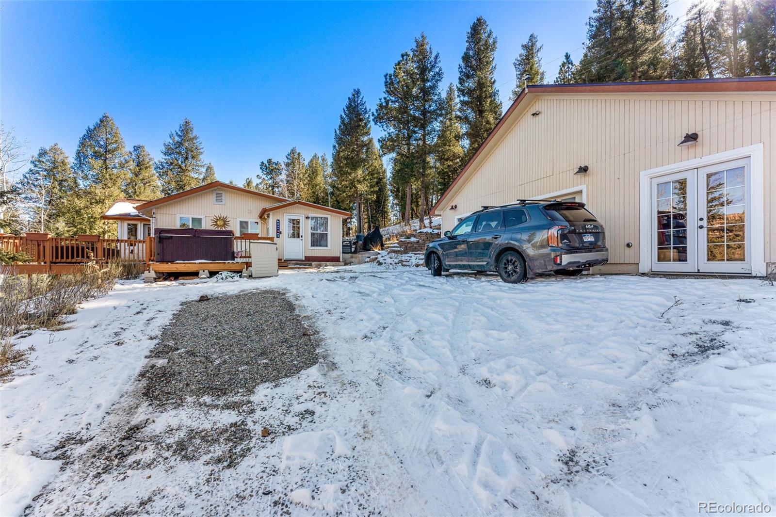 33782 Nova Road Pine, CO 80470 - Photo 34 of 50 a view of a house with a large tree in front of it