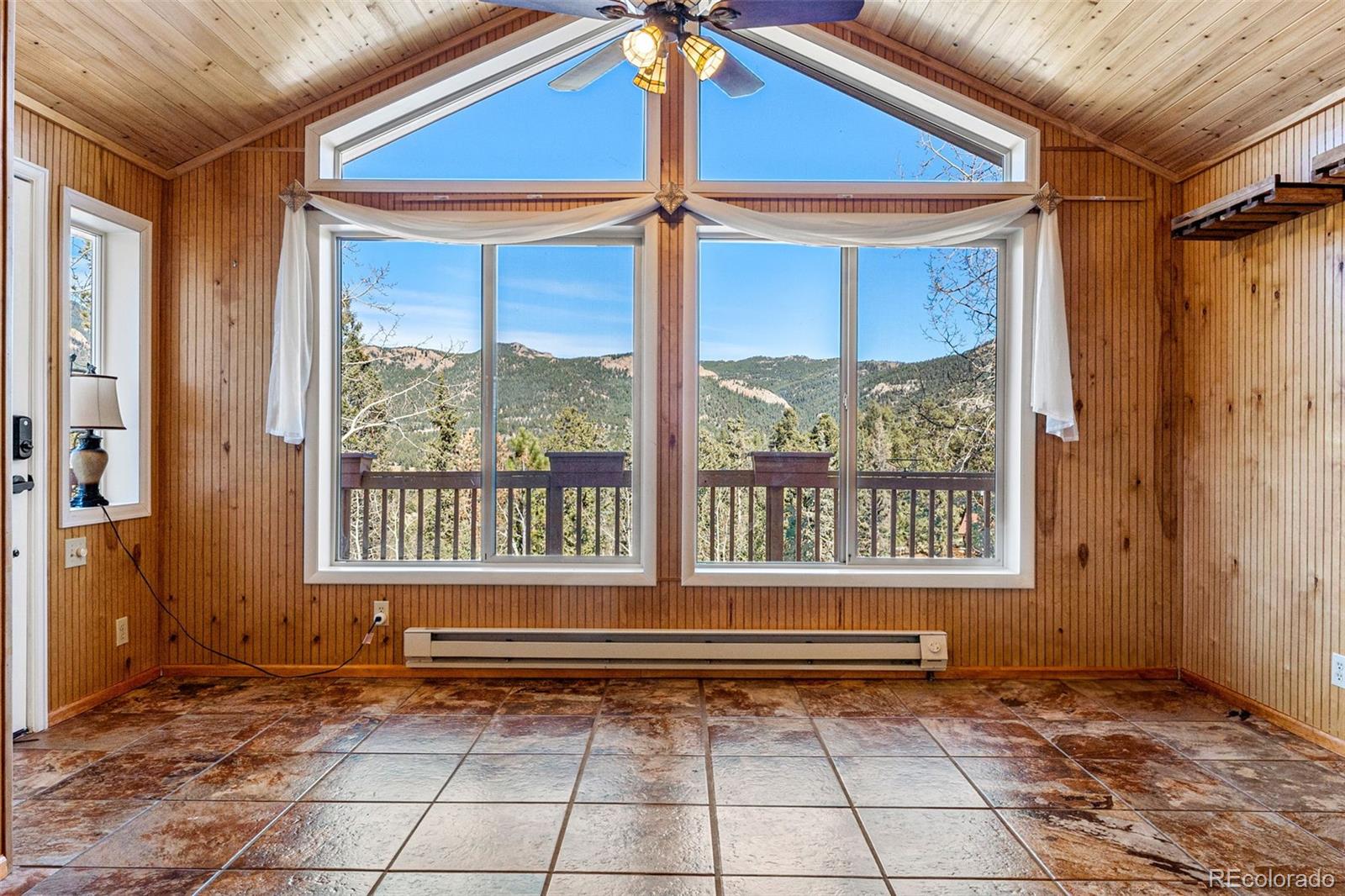 33782 Nova Road Pine, CO 80470 - Photo 4 of 50 a view of a livingroom with a lounge chair and windows