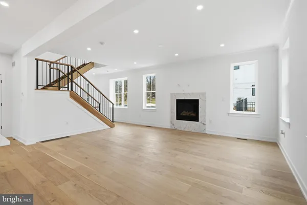 a kitchen with stainless steel appliances granite countertop a sink a stove and a wooden floors