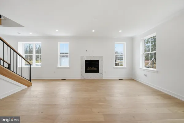 a view of a kitchen with stainless steel appliances wooden floor and a window