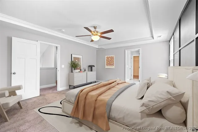 a spacious bedroom with a bed couch and window