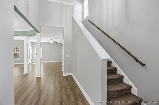a view of entryway and gallery with wooden floor