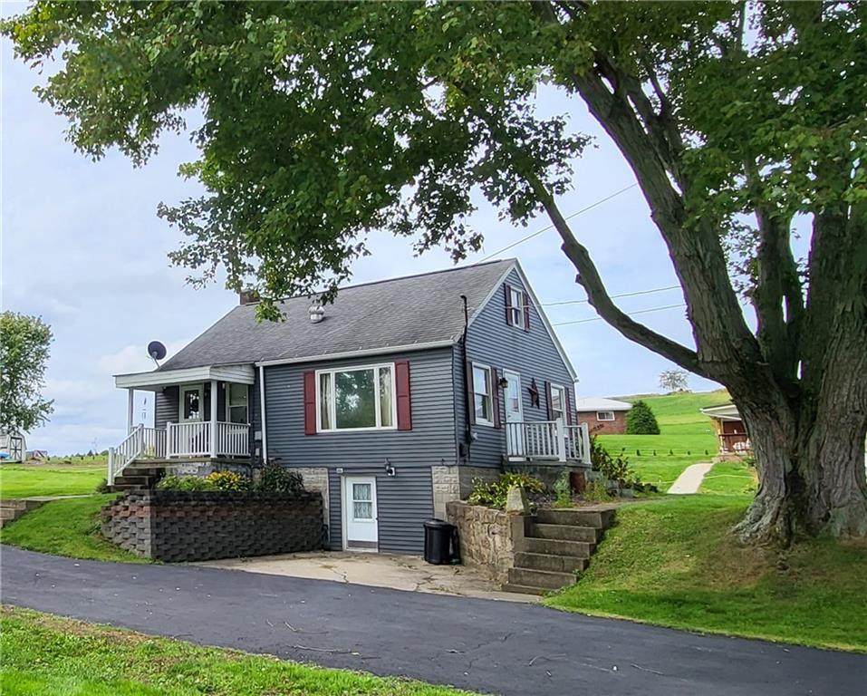 775 Claypoole Road Worthington, PA 16262 - Photo 2 of 18 a front view of a house with a garden