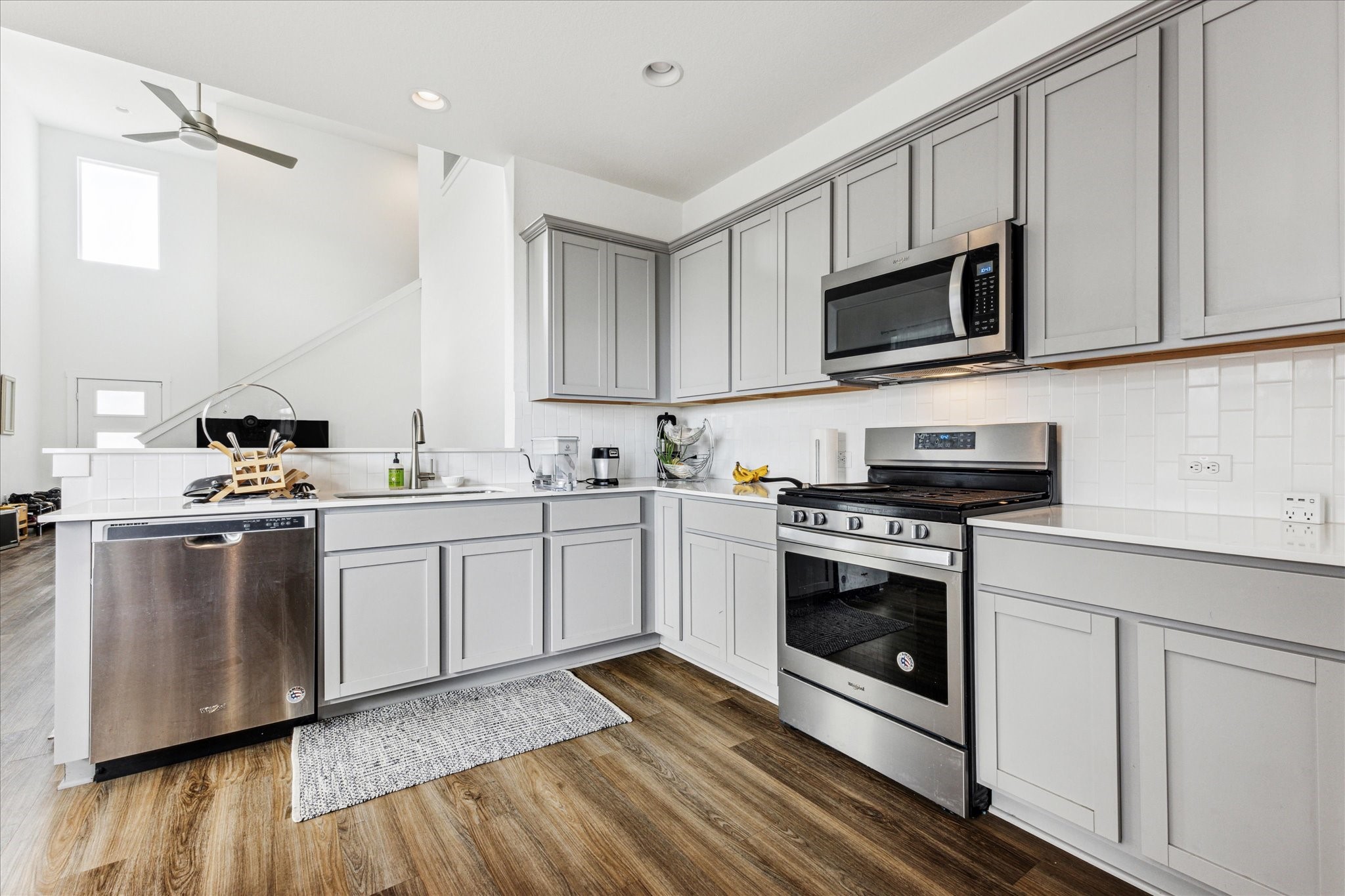 7916 Linnie Lane Austin, TX 78724 - Photo 8 of 13 a kitchen with white cabinets stainless steel appliances and sink