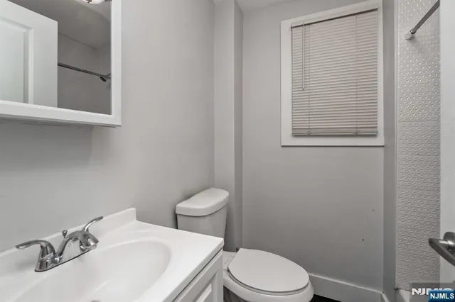 a white toilet sitting next to a bathroom sink