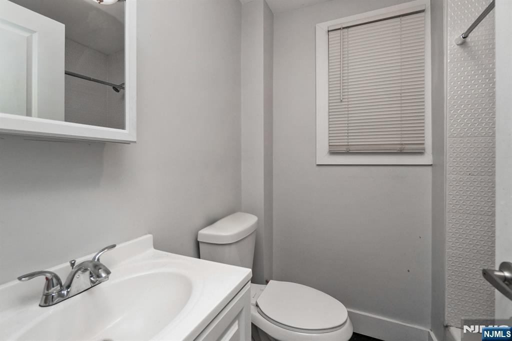 467 Fairview Avenue Orange, NJ 07050 - Photo 12 of 18 a white toilet sitting next to a bathroom sink