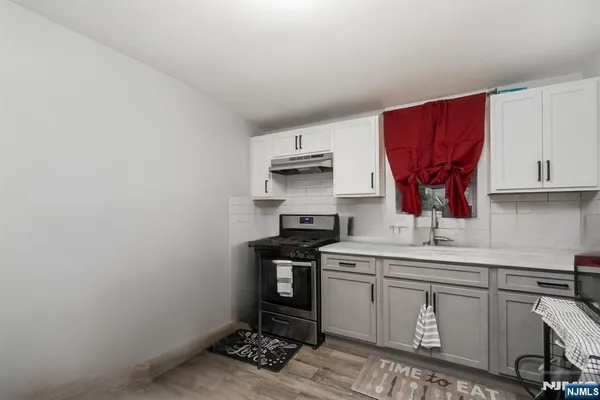 a kitchen with a sink cabinets and appliances