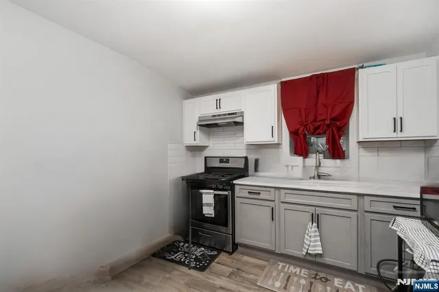 a kitchen with a sink cabinets and appliances