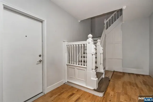 a view of an entryway with wooden floor and door