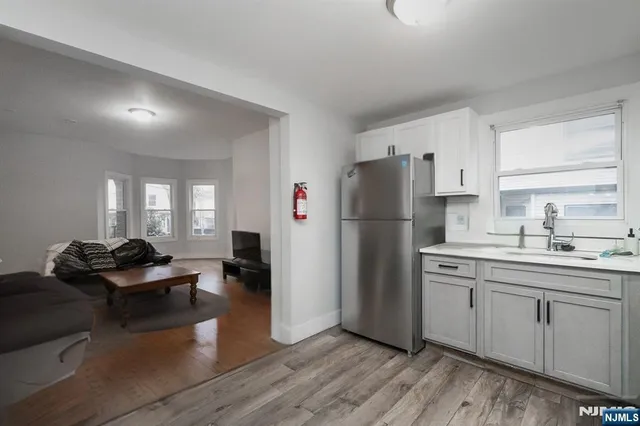 a kitchen with a refrigerator and a sink