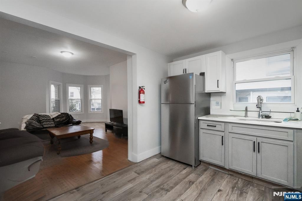 467 Fairview Avenue Orange, NJ 07050 - Photo 7 of 18 a kitchen with a refrigerator and a sink