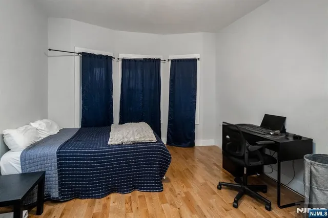a bedroom with a bed and a desk