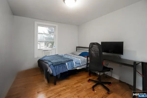 a bedroom with a bed chair and a window