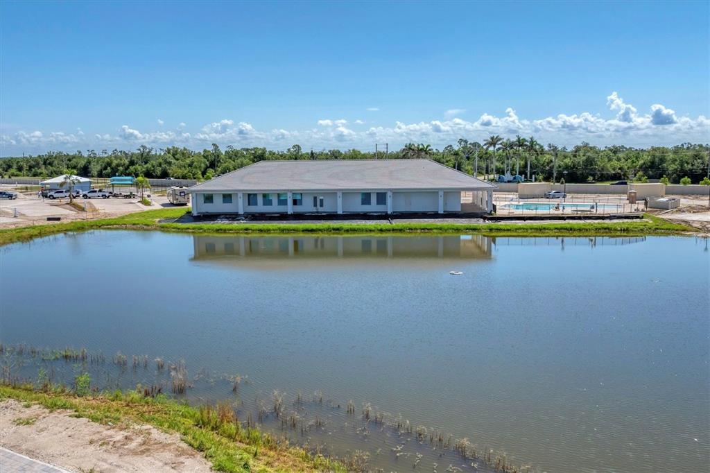 9001 Gasparilla Road, Unit 22 Placida, FL 33947 - Photo 57 of 77 a view of a house with a swimming pool and a yard