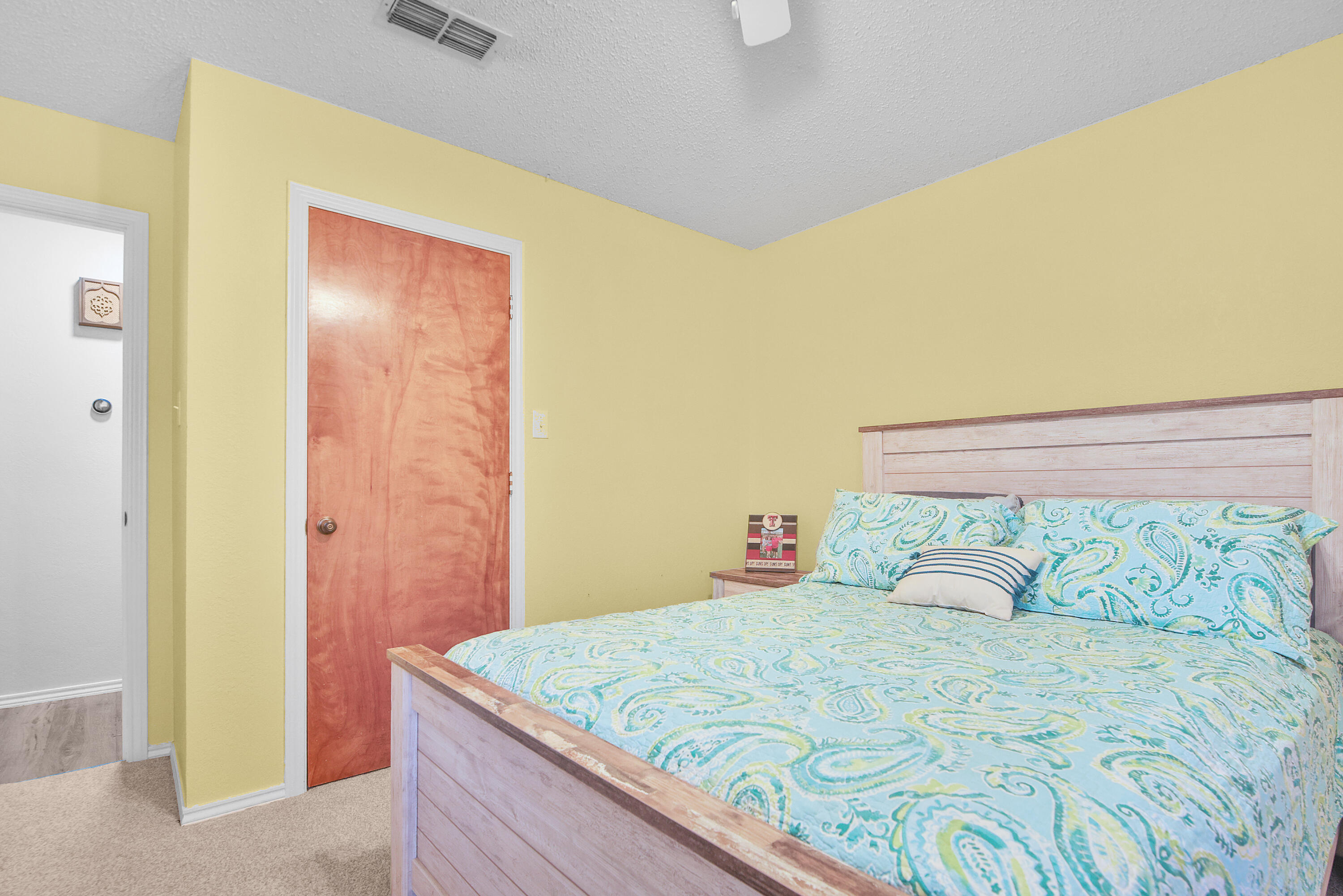 4805 73rd Street Lubbock, TX 79424 - Photo 18 of 26 a bedroom with a bed and a dresser
