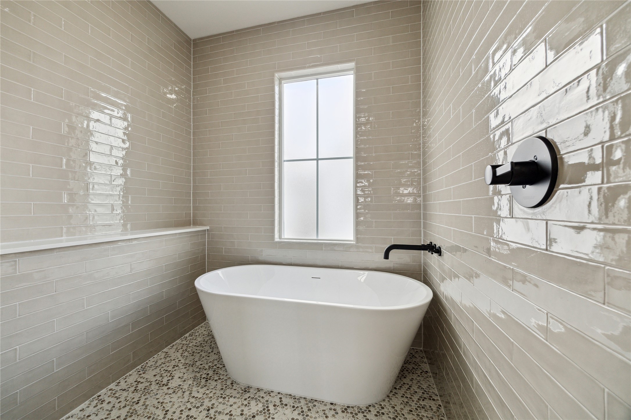 3911 Tulane Street, Unit B Houston, TX 77018 - Photo 18 of 37 Experience luxury in the primary bathroom with a sleek freestanding tub, elegant tile walls, and a bright, airy ambiance.