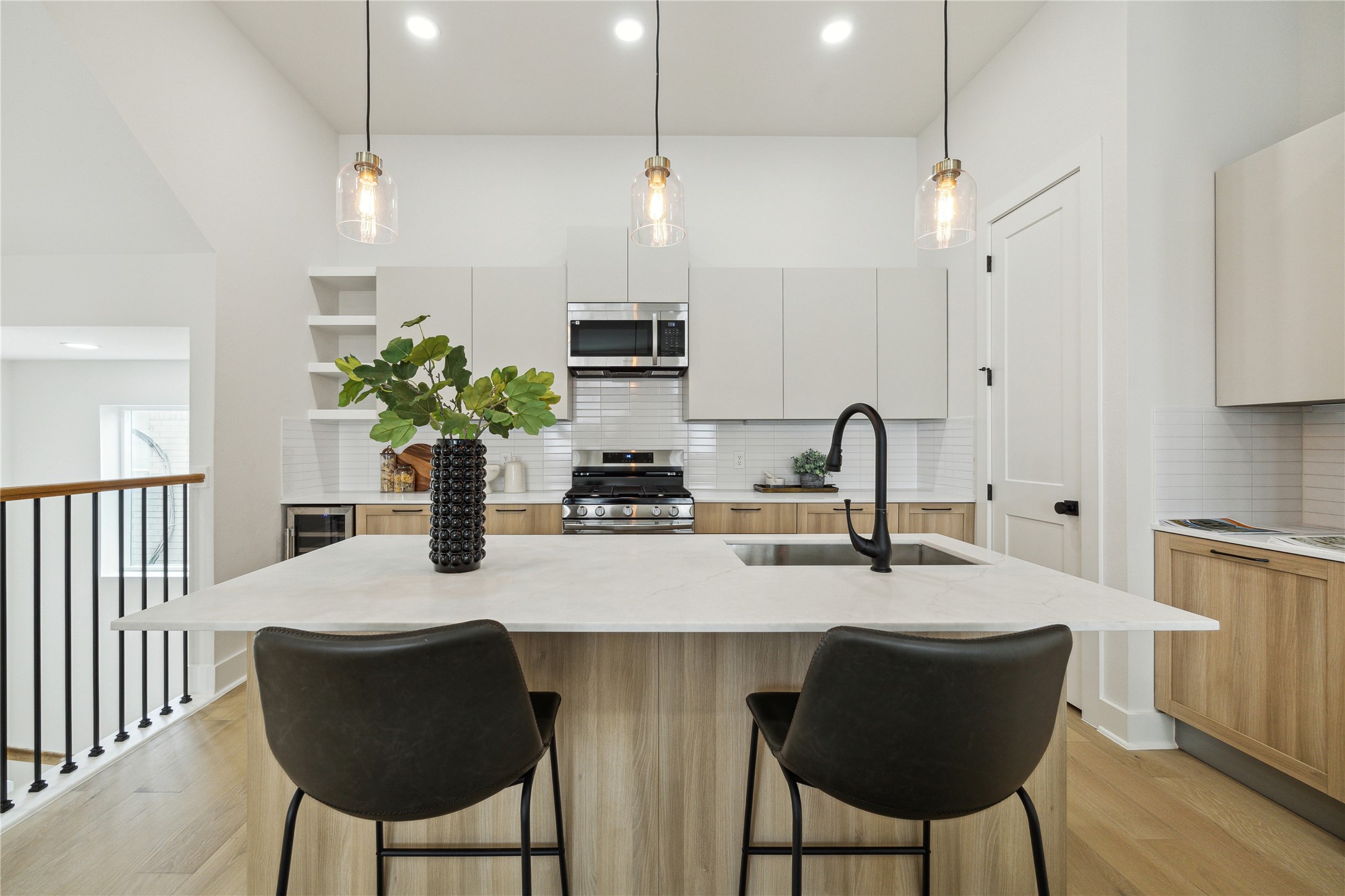 3911 Tulane Street, Unit B Houston, TX 77018 - Photo 3 of 37 Modern kitchen featuring sleek cabinetry, stainless steel appliances, and an inviting island with stylish pendant lighting. Ideal for cooking and entertaining.