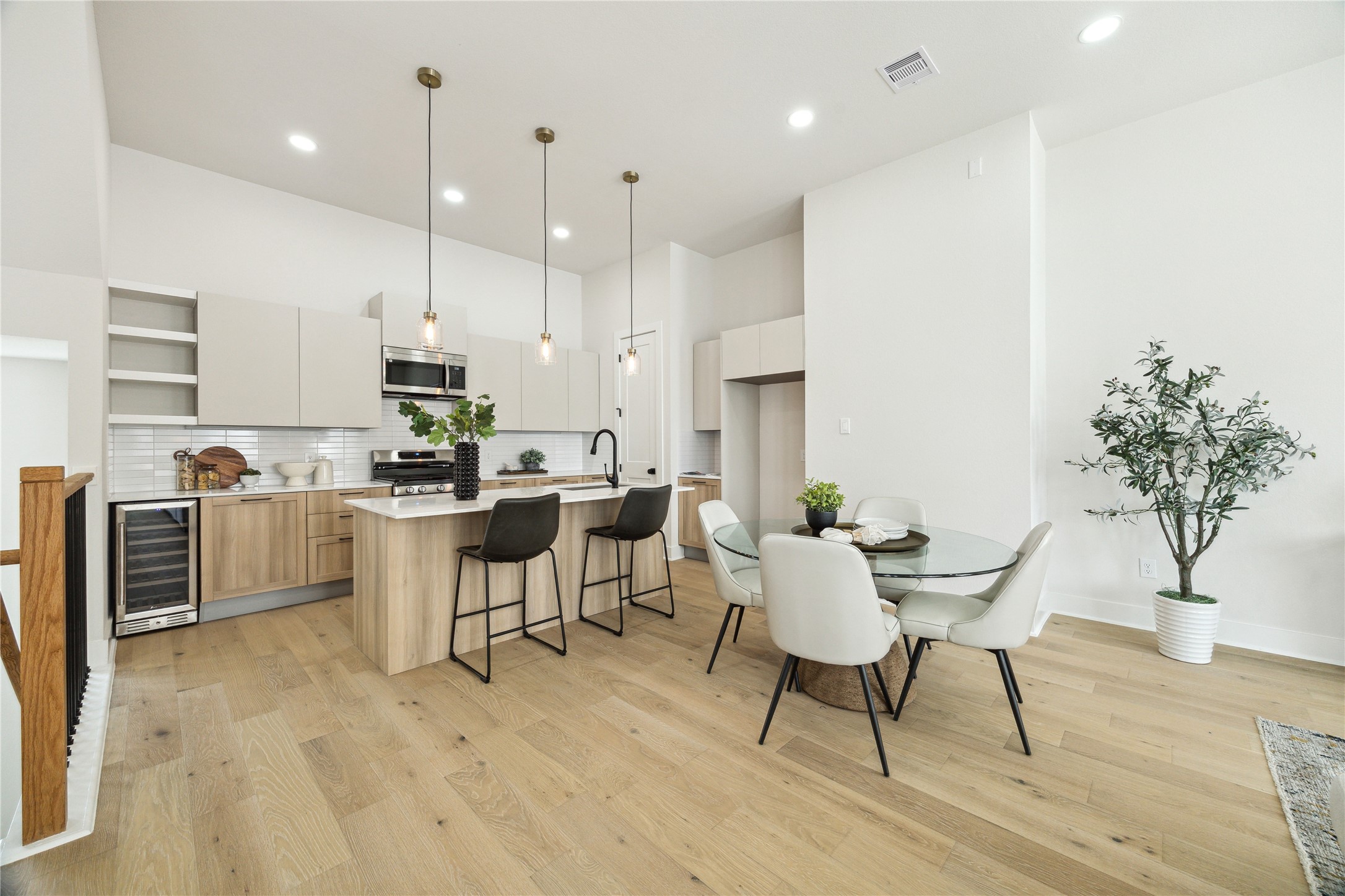 3911 Tulane Street, Unit B Houston, TX 77018 - Photo 8 of 37 Modern kitchen with sleek cabinetry, stainless steel appliances, and a spacious island. Adjacent dining area offers ample seating, perfect for entertaining.