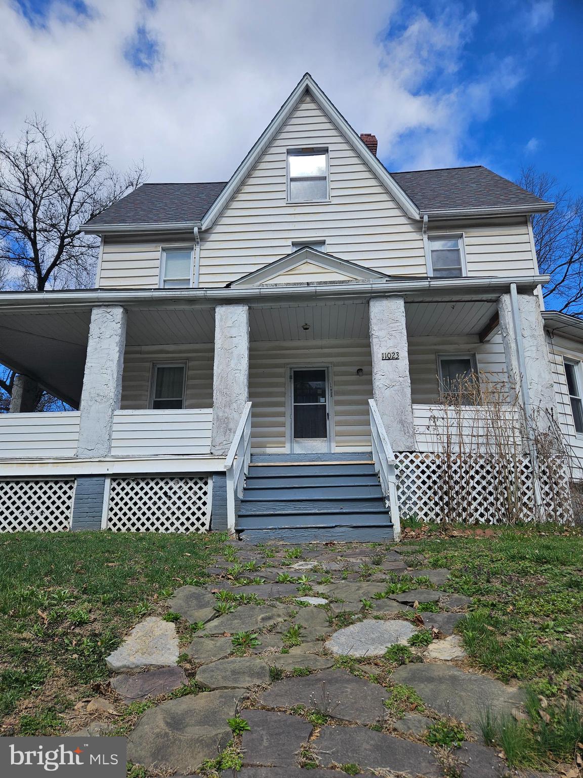 a front view of a house with a garden